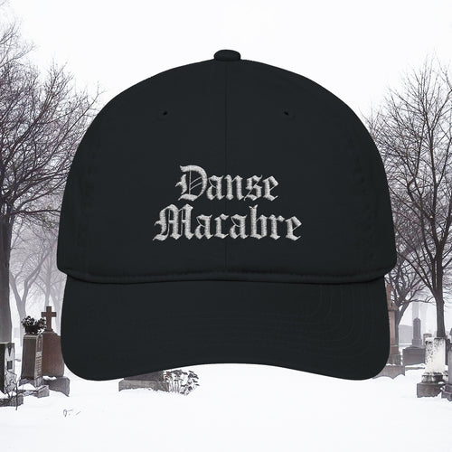 Grant Us Night black cap with white embroidered 'Danse Macabre' text in a snowy cemetery