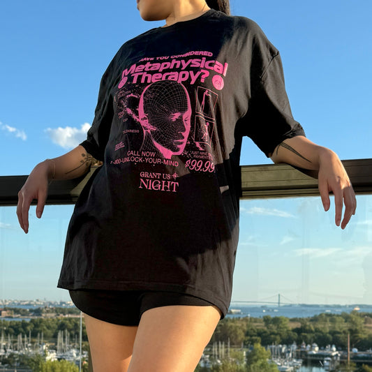 Model wearing Grant Us Night Metaphysical Therapy black shirt with pink purple fuschia text graphic design of a 3D mesh human head and a galaxy and alien diagrams on a starry night background