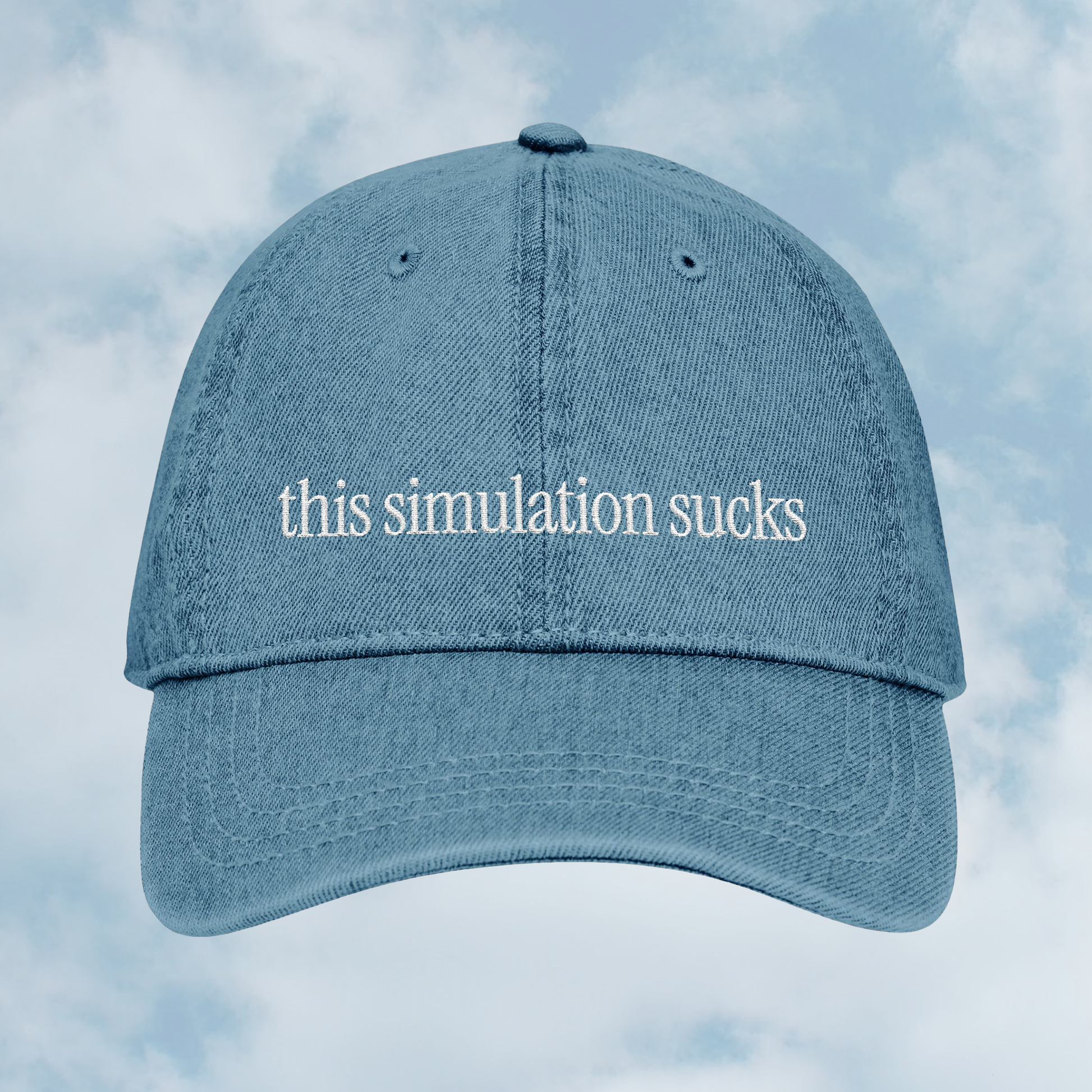 Grant Us Night Simulation blue denim cap with 'this simulation sucks' white text embroidered against a blue sky background